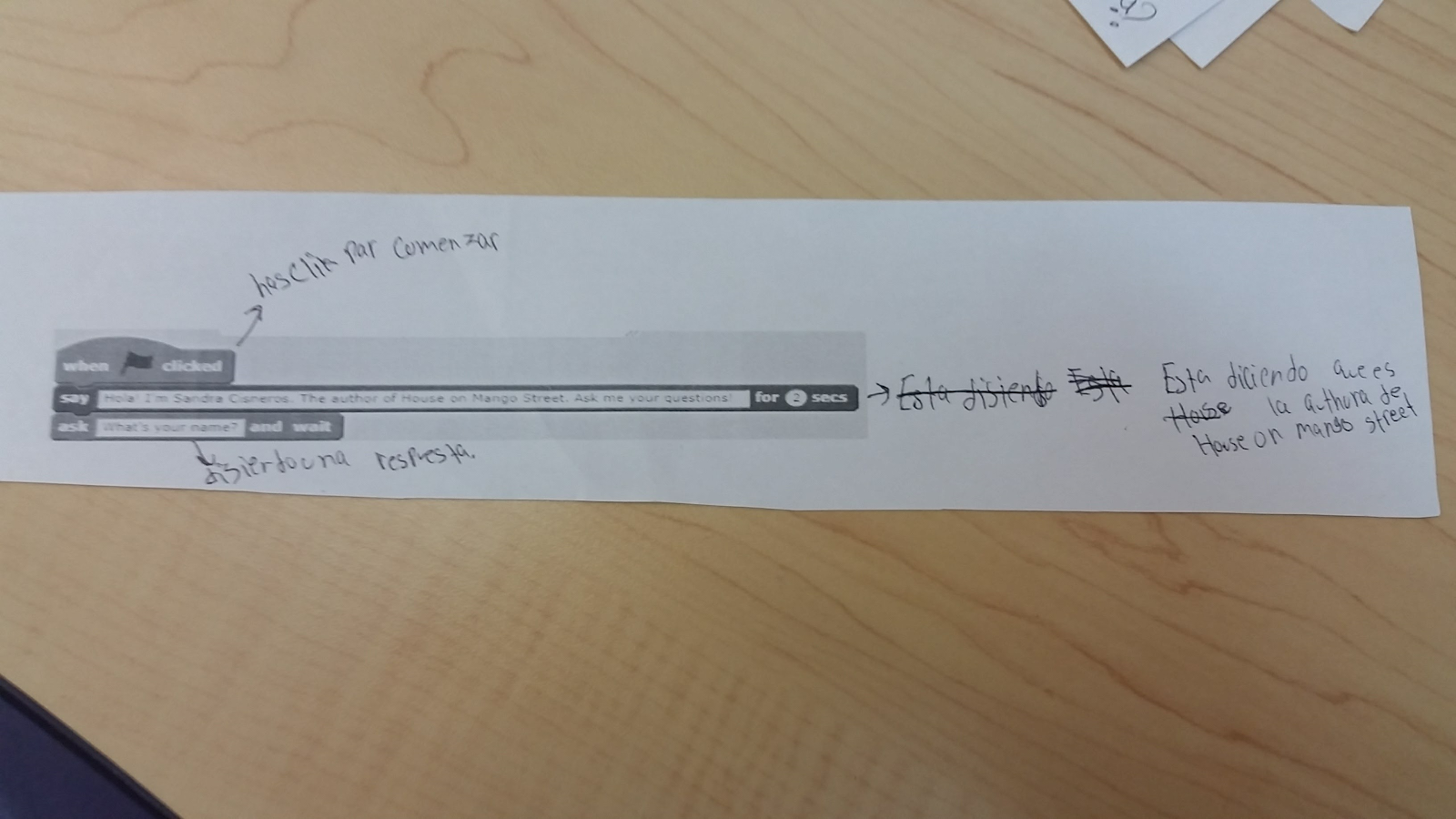 Student annotations of Scratch code printed on paper.